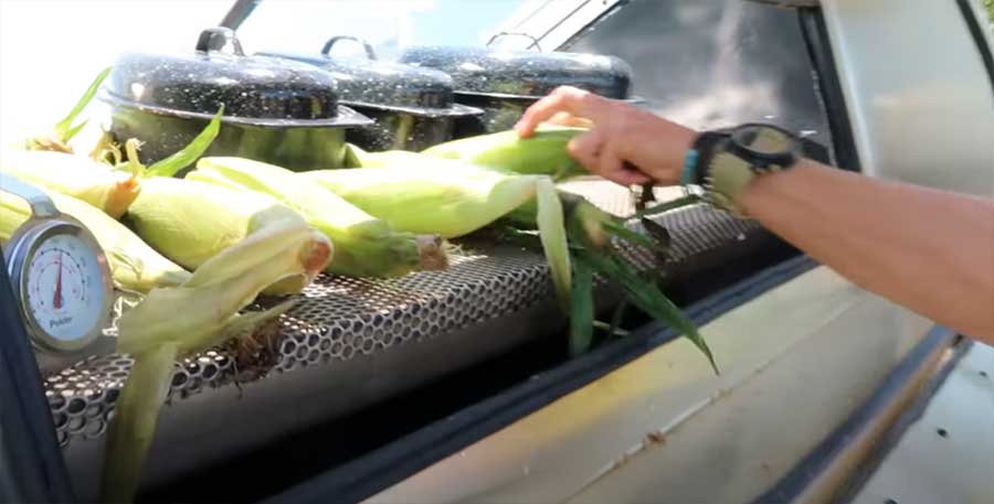 Adding food to the Sun Oven